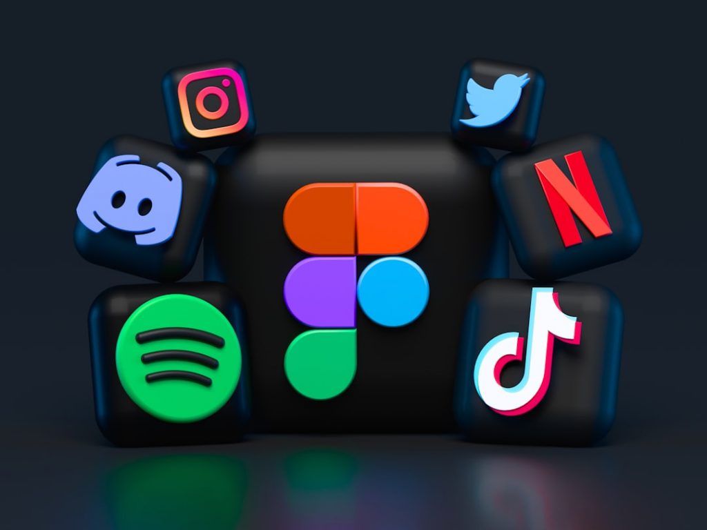 3D icons of social media and streaming platforms, including Instagram, Twitter, Discord, Netflix, Spotify, TikTok, and Figma, are arranged on a dark background.
